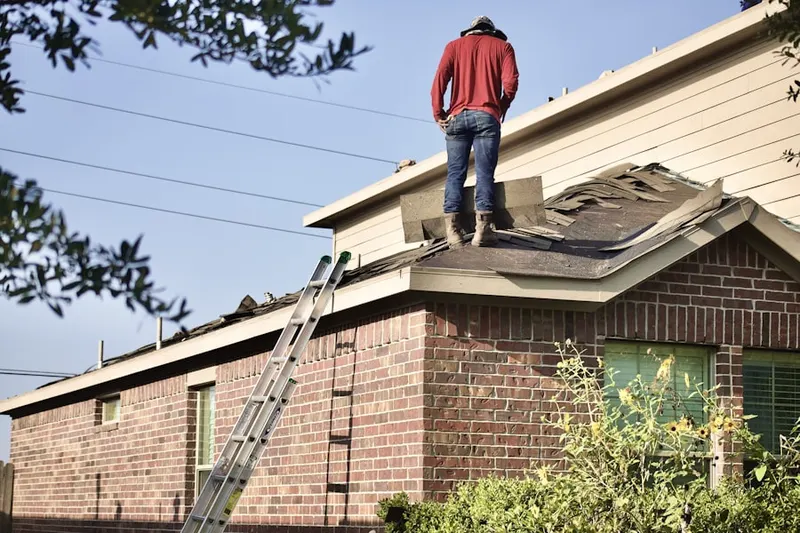 Professional roofer working on a residential roof in Kanuga Park